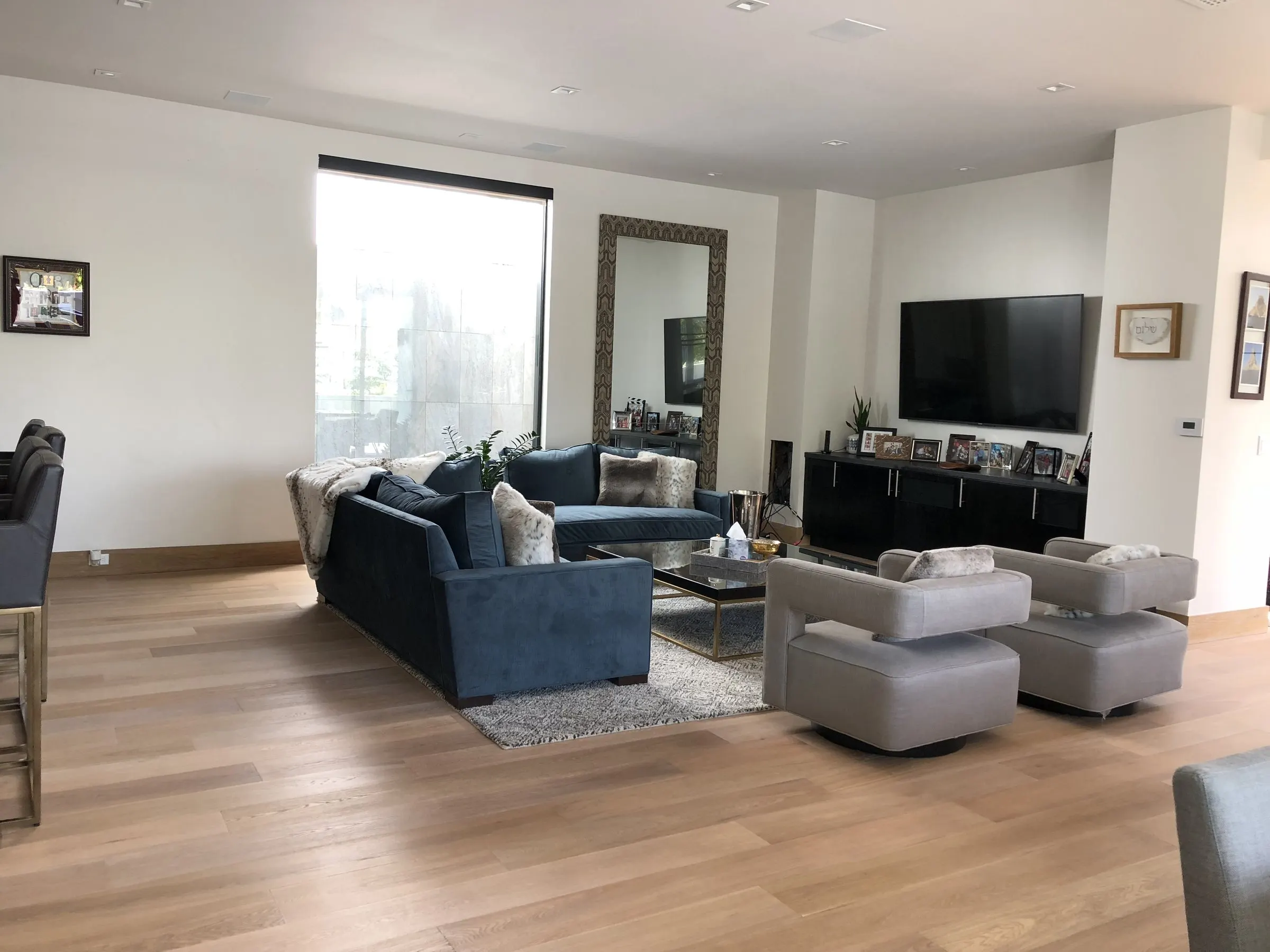 Modern living room with blue sofas and a wall-mounted display