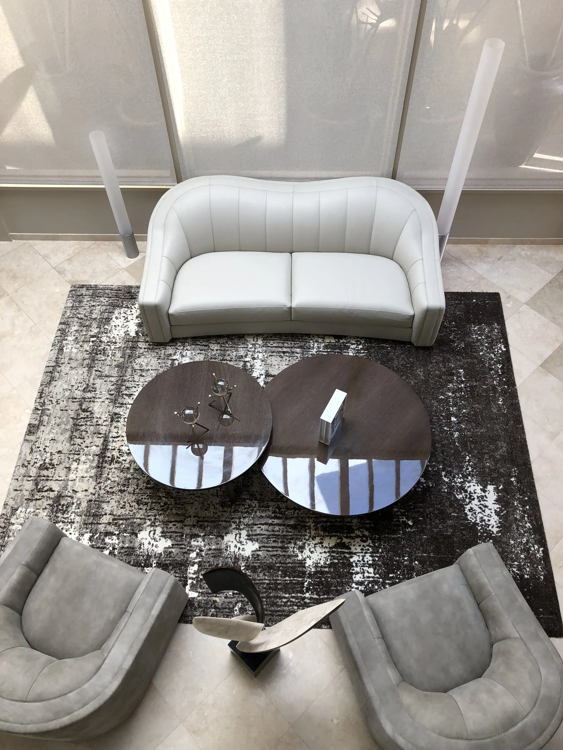 Sitting room seen from above with sheer shades softening bright daylight